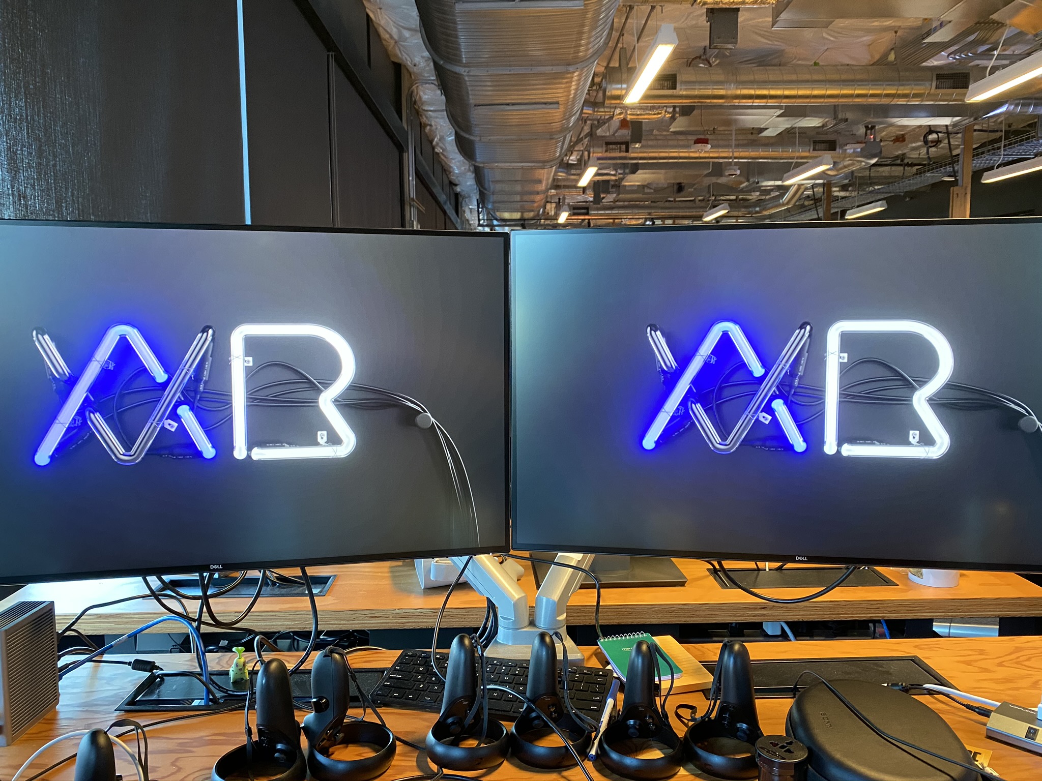 A view of my desk at the Oculus office, with multiple pairs of VR controllers